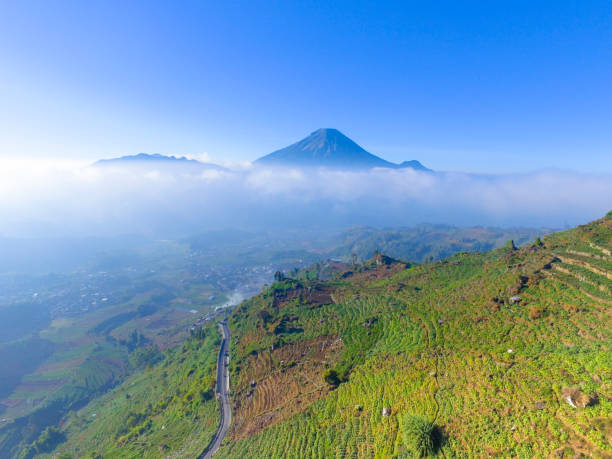 istock Mountain landscape with peaks covered by clouds 1195472505
