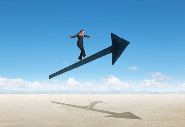 istock Businesswoman Balancing On Arrow 1195472606