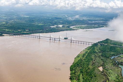 Orinoquia bridge over Orinoco river. Puerto Ordaz, Venezuela. The Orinoco is the second river in South America following the Amazon River in Brazil. It is one of the longest rivers with 2,140 km and its drainage basin covers 880,000 square kilometres. The Orinoco and all its tributaries are the main transport system for eastern and interior Venezuela and the llanos of Colombia.
