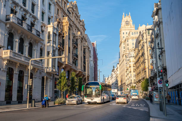 Madrid / Spain - October 19, 2019: Traffic downtown Madrid, along the famous Gran Via, which runs through the center of the city. Bus in view.