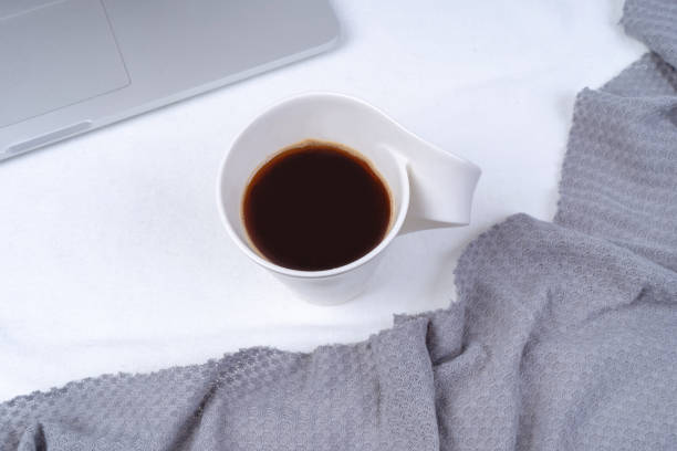 istock Office workspace with cup of coffee, laptop, knit a blanket on white background. 1195475977