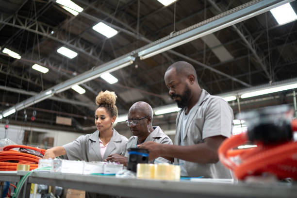 istock Team working together in a factory 1195478873