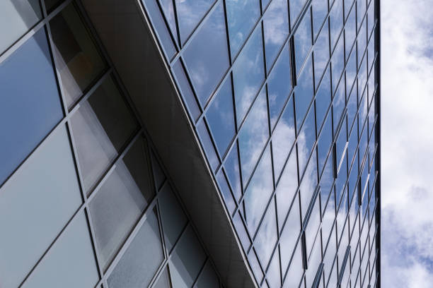 istock Side view of glass surface on modern building facade with reflected sky on it. 1195481311