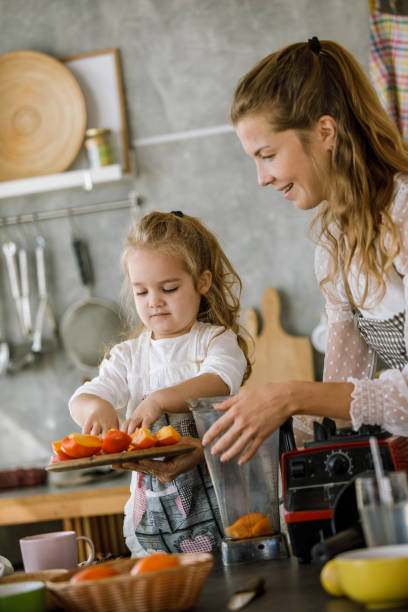 istock Adding freshly cut persimmons into blender for a tasty dessert 1195481538