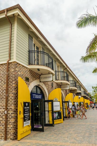 Tanzanite International store inside the Falmouth Cruise Port, Trelawny parish, Jamaica. Young millennial caucasian girls/ people entering the store. Falmouth, Jamaica - June 03 2015: Tanzanite International store inside the Falmouth Cruise Port, Trelawny parish, Jamaica. Young millennial caucasian girls/ people entering the store. falmouth harbor stock pictures, royalty-free photos & images