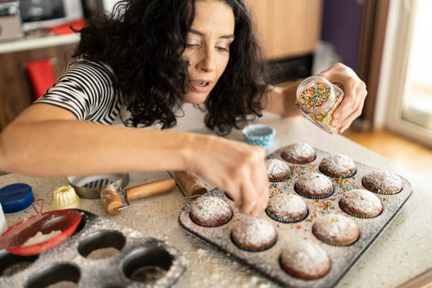Woman decorating muffins