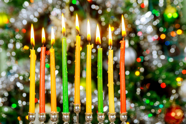 istock Hanukkah background with menorah and burning candles on sparkle background with defocused lights. 1195484856