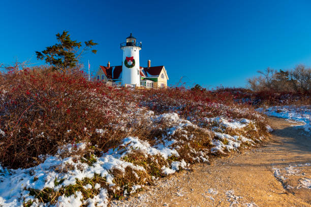 Noska Lighthouse decorated with a wreath for Christmas Nobska lighthouse on Cape Cod on a sunny winter day before Christmas cape cod photos stock pictures, royalty-free photos & images