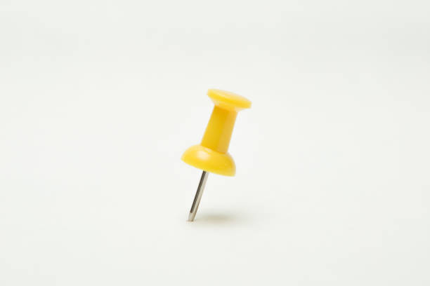 istock Close up of Yellow pin on white background 1195488910