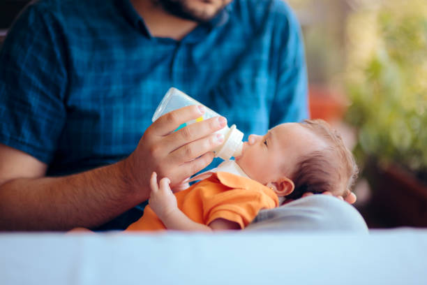 istock Father Feeding Newborn Baby in a Restaurant 1195493599