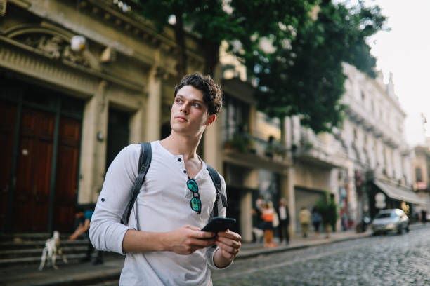 istock Handsome guy using smartphone in the street in Buenos Aires 1195496228