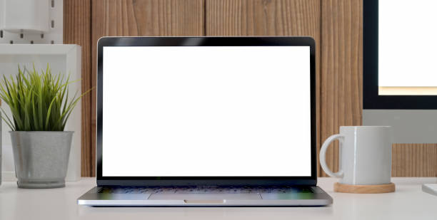 istock close-up view of blank screen laptop computer with coffee cup and tree pot on the table 1195497950