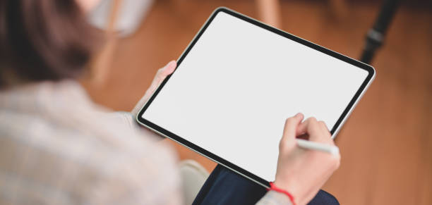 istock Cropped shot of businesswoman working on her project while using blank screen digital tablet 1195498013