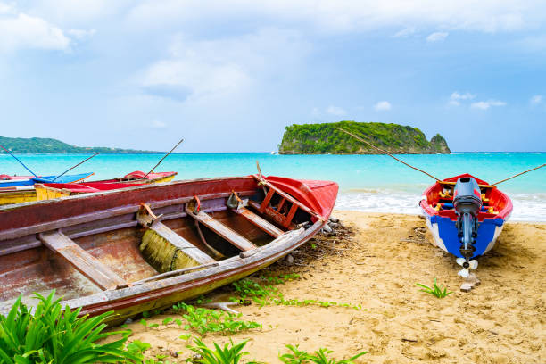 colorful old wooden fishing boats docked by water on a beautiful beach coast. white sand sea shore landscape on tropical caribbean island. - cabarita beach imagens e fotografias de stock