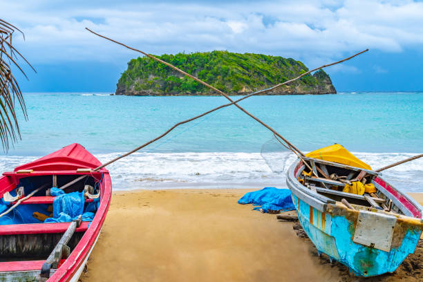 colorful old wooden fishing boats docked by water on a beautiful beach coast. white sand sea shore landscape on tropical caribbean island - cabarita beach imagens e fotografias de stock
