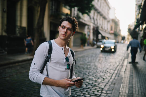 istock Handsome guy using smartphone in the street in Buenos Aires 1195499652