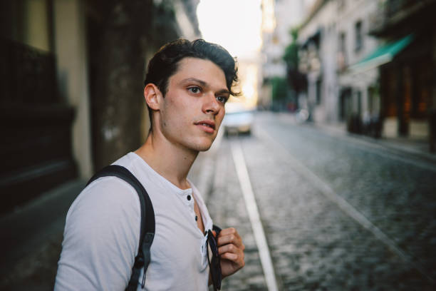 istock Handsome guy standing in the street 1195499741