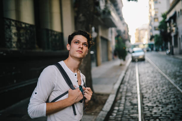istock Handsome guy standing in the street 1195500462