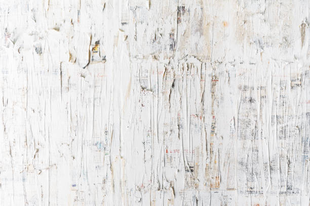 istock Rough white painted on newspaper wall. Perfect for background. Abstract  texture. White wallpaper. 1195502240