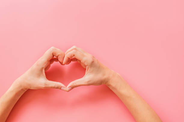 istock Valentine's day background. Female hands making hearth shape. Flat lay, top view, mockup, template, copy space. Minimal abstract composition for 14 February celebration 1195504054