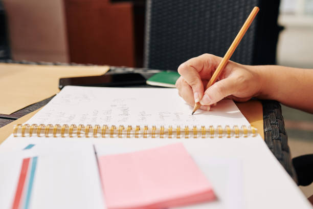 istock Woman writing in textbook 1195506028