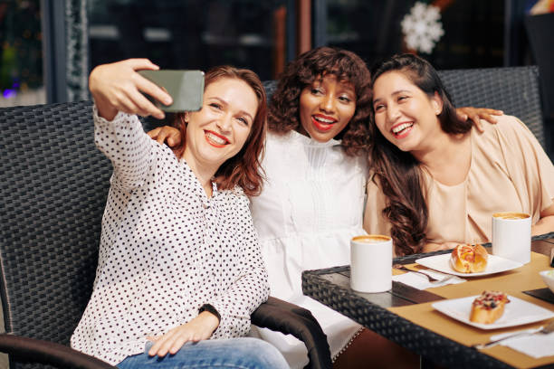 istock Happy friends posing for selfie 1195506087