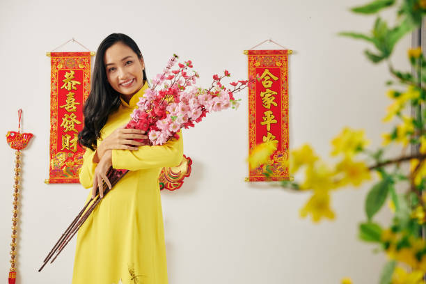 istock Young woman with peach branches 1195506195