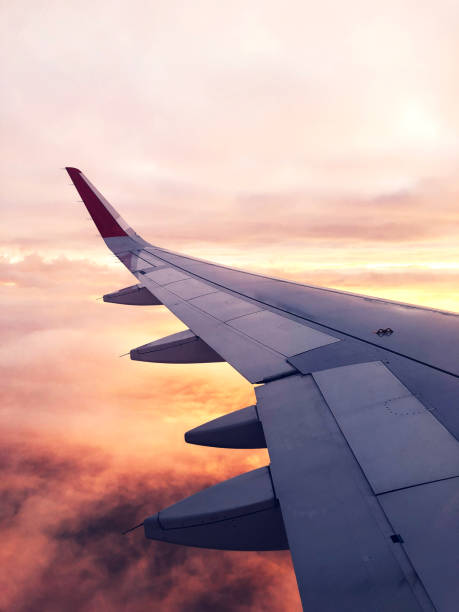 istock Clouds and sky through window of an airplane. 1195515827