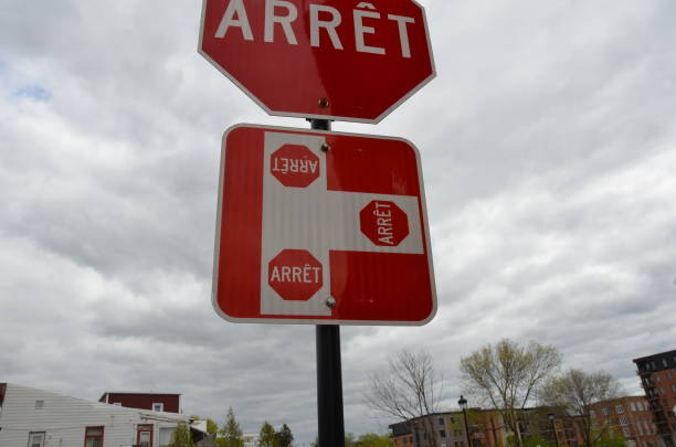 istock three way stop or arret sign in Canada 1195522289