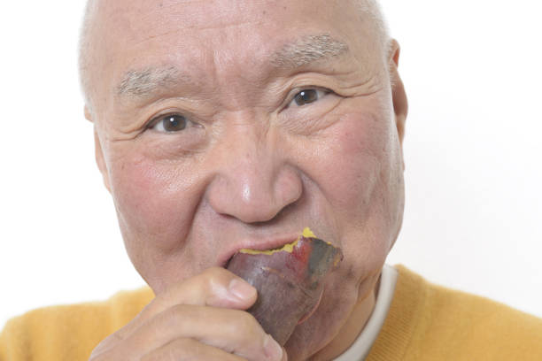 istock Senior eating sweet potato 1195524199