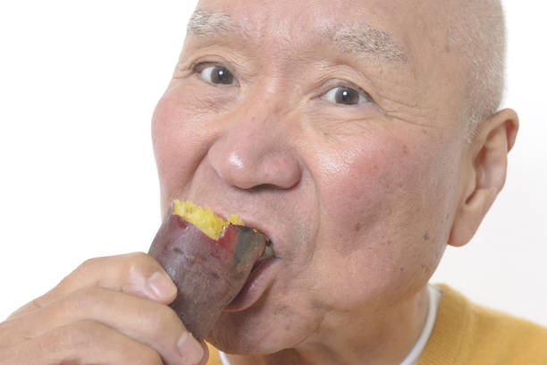 istock Senior eating sweet potato 1195524226