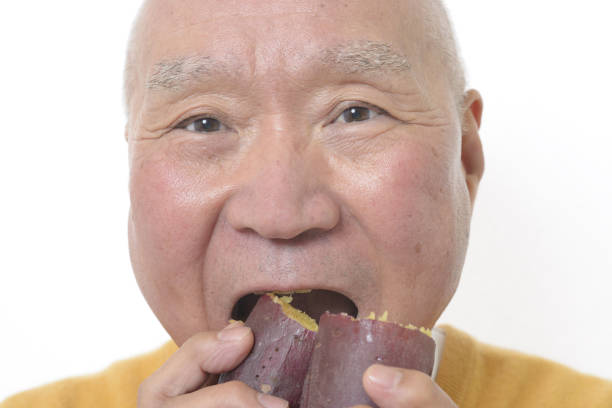 istock Senior eating sweet potato 1195524233