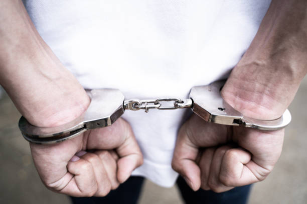 istock Male hands arrested with handcuffs in Criminal concept. 1195525462