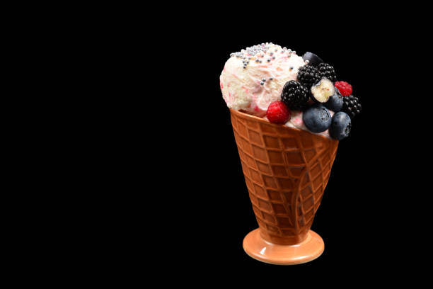 istock Ice cream with blueberries, blackberries and raspberries on a black background.  Copy space. 1195525751