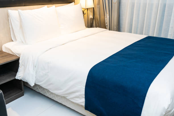 istock White comfortable pillow and blanket on bed decoration in bedroom 1195528383