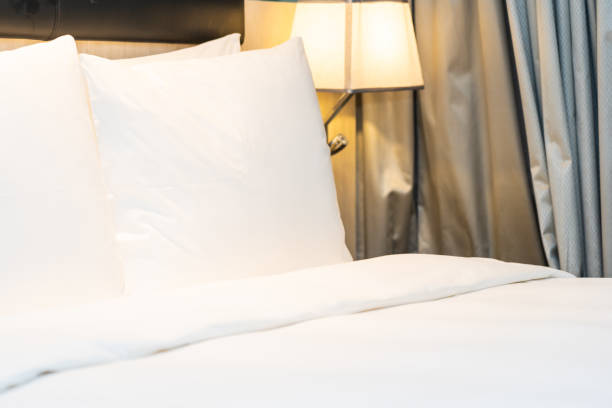 istock White comfortable pillow and blanket on bed decoration in bedroom 1195528408