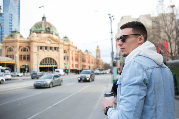 istock Young Man Walking Along Flinders Street 1195529247
