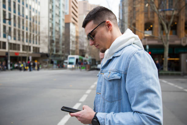 istock Man Checks Directions in Downtown Melbourne 1195529251
