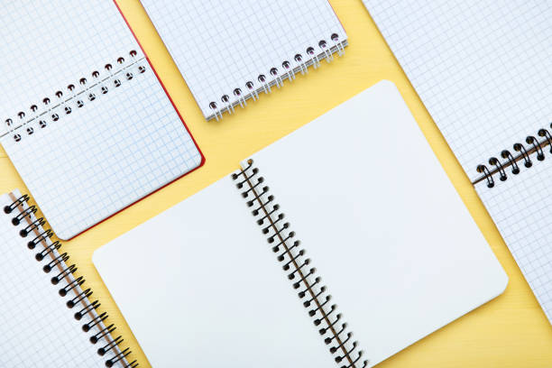 istock Blank notepads on yellow wooden table 1195529423