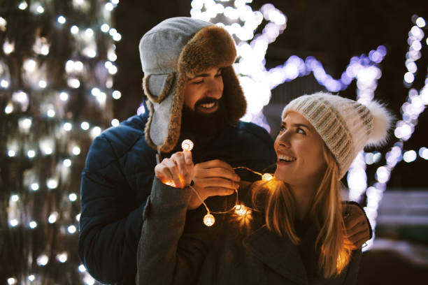 istock Young couple having a romantic moment outdoors at night 1195529543