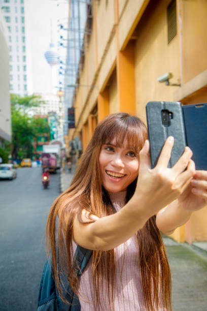 istock Young woman in Kuala Lumpur 1195530528