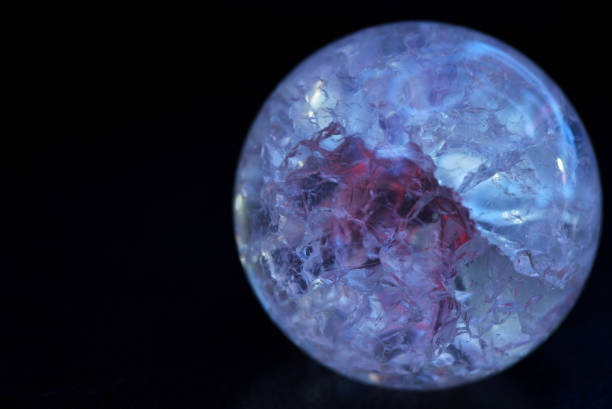 istock Glowing crystal ball with cracks inside on a dark background. The process of predicting the future 1195530754