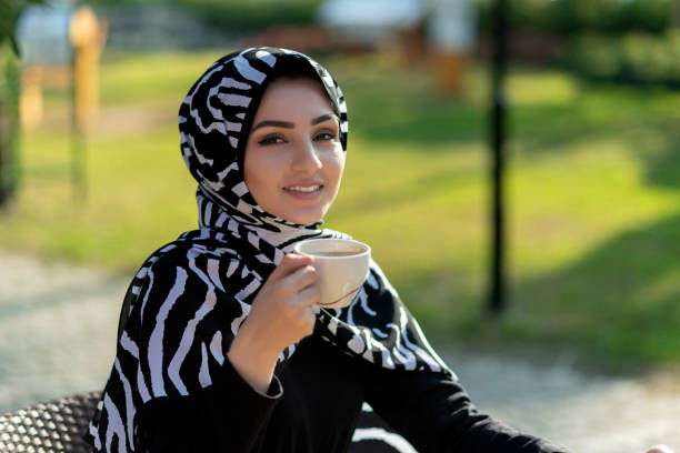 istock Young beautiful muslim female holding coffee cup 1195530920