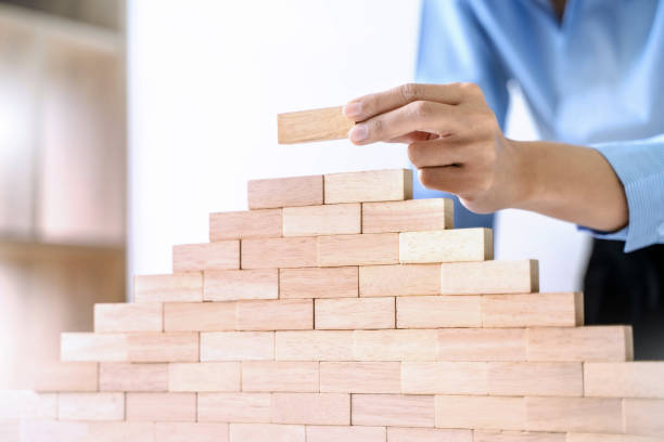 istock hand building up the tower, Business risk and strategy concept. 1195532417