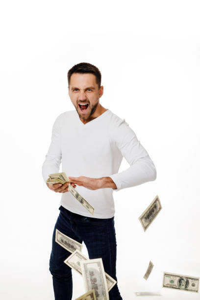 istock man throwing out money banknotes 1195532822