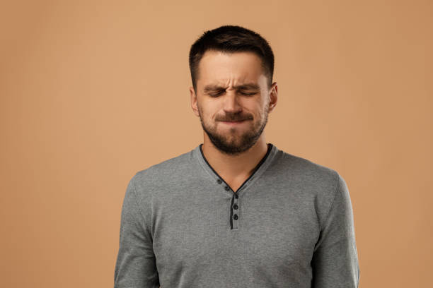istock young bearded man with frowns face 1195533067