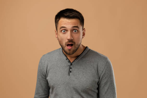 istock Portrait of young surprised handsome bearded man 1195533615