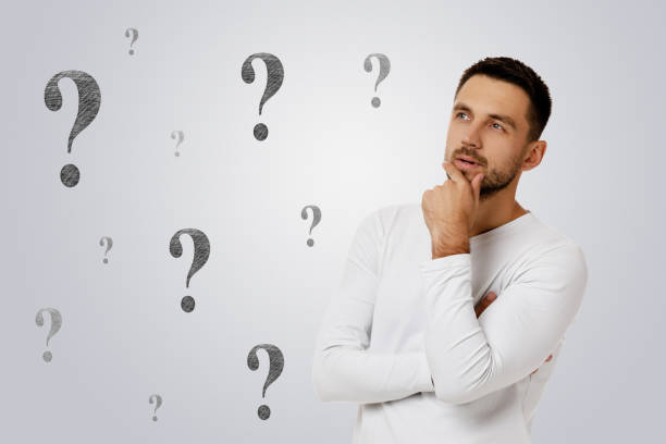 istock bearded man in casual white shirt asking questions 1195534123