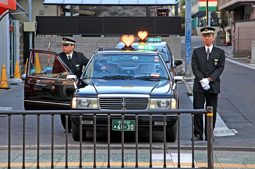 Ishiyama, Japan on 31st March 2012. Two taxi drivers waiting for customers at Ishiyama train station near Kyoto.