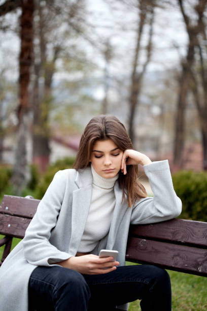 istock beautiful woman with smart phone 1195538314